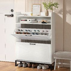 a white shoe rack sitting on top of a wooden floor