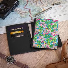 a passport, wallet and camera sitting on top of a table next to a map