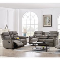 a living room with two recliners and a coffee table in front of windows