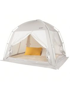 a white tent with yellow pillows on the bed and pillow in it's corner