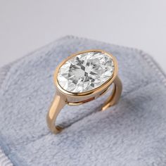 a diamond ring sitting on top of a blue towel