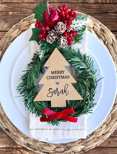 a white plate topped with a christmas tree napkin