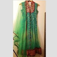 Gorgeous Green And Red Long Anarkali Dress Sleeveless Size Small Having Net Overlay Comes With Red Patchwork Hem Comes With Green Shawl (Dupatta) Brand New Traditional Sleeveless Navratri Dresses, Multicolor Sleeveless Dress For Diwali, Sleeveless Dress With Sheer Dupatta For Diwali, Traditional Sleeveless Cutdana Dress, Chanderi Sleeveless Dresses For Festivals, Semi-stitched Sleeveless Dress With Dupatta, Festival Sleeveless Chanderi Dresses, Sleeveless Cutdana Salwar Kameez For Festivals, Sleeveless Chanderi Anarkali Dress