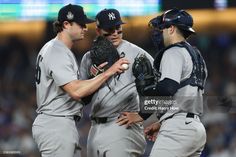 three baseball players are talking to each other in the middle of a game stock photo