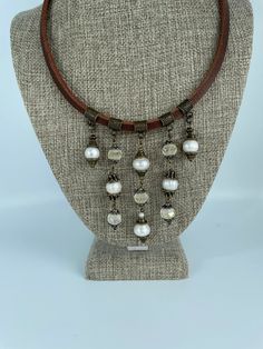 This necklace is truly one of a kind. It is uniquely elegant with its antiqued vintage appeal, yet the brown leather allows you to wear it with jeans and a tee shirt. You will want to wear this necklace every day.  The leather is cut 4.5mm in thickness. It is a rich dark brown leather with a distressed sienna color on the back side. There are 3 bronze antiqued connecting beads as well as 2 bronze spacer beads.  There are freshwater cultured pearls in multiple sizes, and shapes. Pearls have their Brown Leather Jewelry With Soldered Details, Vintage Bronze Leather Jewelry, Elegant Brown Soldered Jewelry, Vintage Adjustable Leather Necklace, Adjustable Leather Vintage Necklace, Vintage Brown Leather Jewelry, Vintage Leather Necklace As Gift, Vintage Leather Necklace For Gift, Polymer Clay Necklace