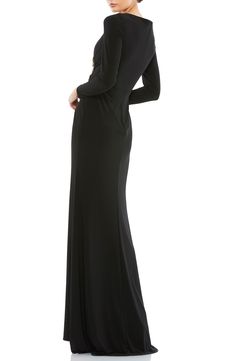 Twinkling rhinestones crown the embroidered center detail of this soft and stretchy jersey gown that has a floor-skimming skirt and back zipper for convenience. 63" length V-neck Long sleeves Lined 100% polyester Spot clean Imported Formal Long Sleeve Maxi Dress In Elastane, Formal Long-sleeve Elastane Maxi Dress, Elegant Long Sleeve Stretch Gown, Black Mac, Mac Duggal Dresses, Rhinestone Crown, One Shoulder Gown, Long Sleeve Evening Dresses, Dress Home