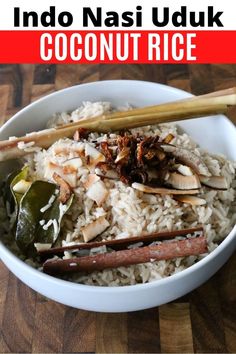 there is a bowl with rice and vegetables in it on the table next to some chopsticks