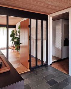 an open kitchen and living room with sliding glass doors