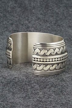 This stunning sterling silver bracelet was made by Navajo silversmith Raymond Delgarito. The back is signed RD and stamped sterling.Size: 5 1/4" (will fit up to a 6 1/4" wrist)Gap: 1"Width: 1 1/4"Free shipping on all orders! We ship with USPS and always include tracking. All orders ship within a day of payment.Returns are accepted up to 30 days after you receive your order. Just send us a message. Our shop offers cash back or store credit. The item must be returned in new condition. Bohemian Wide Band Engraved Jewelry, Southwestern Engraved Sterling Silver Bracelet Gift, Engraved Sterling Silver Bracelet Gift, Traditional Nickel-free Sterling Silver Bracelet, Traditional Sterling Silver Nickel-free Bracelet, Sterling Silver Cuff Bracelet With Intricate Design, Collectible Wide Band Engraved Jewelry, Southwestern Sterling Silver Bracelet Stamped 925 As Gift, Collectible Engraved Wide Band Jewelry