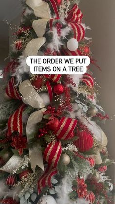 a christmas tree decorated with red and white ribbons, ornaments and bows that say the order we put items on a tree