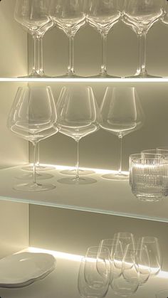 there are many wine glasses on the shelves