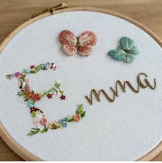 a close up of a embroidery on a hoop with the word mom written in it