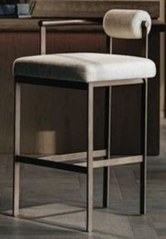 a white counter top sitting next to a wooden table and chair in a room with tile flooring