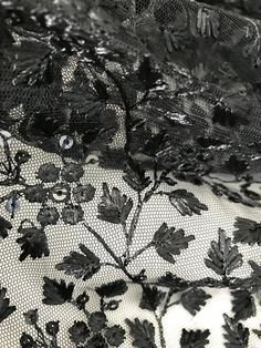 black and white photograph of lace with flowers on it