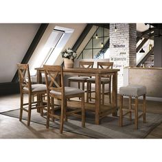 a dining room table and chairs in an attic