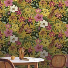 a table and chairs in front of a wallpaper with flowers on the wall behind it