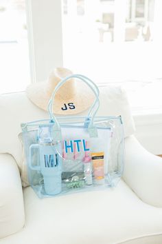 a white chair with a blue bag and hat on it