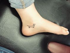 a small dachshund dog tattoo on the left side of the foot,