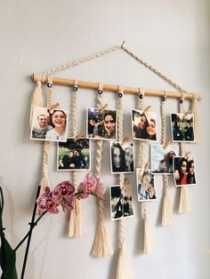 a wall hanging with pictures and tassels attached to it