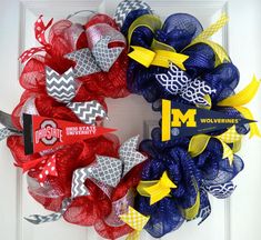 a red, white and blue mesh wreath with michigan wolverines on the front door