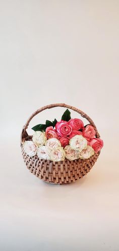 a basket filled with flowers on top of a white table