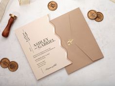 the wedding stationery is laid out with wax stamps