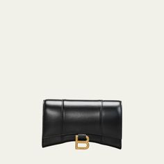 Balenciaga hourglass-shaped crossbody bag in sleek calf leather. Detachable chain shoulder strap; 20" drop Flap top with metal B hardware; snap closure. Exterior, slip compartment at back. Interior, zip and slip pockets. Nappa lambskin lining. 4.7"H x 7.6"W x 1.9"D Wipe with a soft cloth. Made in Italy. Chic Wallet On Chain With Metal Logo For Everyday, Leather Wallet On Chain With Metal Logo For Evening, Chic Evening Wallet On Chain With Metal Logo, Classic Evening Wallet On Chain With Metal Logo, Classic Leather Wallet On Chain With Metal Logo, Chic Wallet On Chain With Gold-tone Hardware For Business, Chic Business Wallet On Chain With Chain Strap, Chic Wallet On Chain With Chain Strap For Business, Chic Wallet On Chain For Business