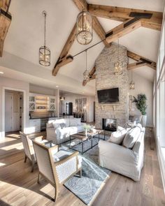 a living room filled with furniture and a fire place next to a wall mounted tv