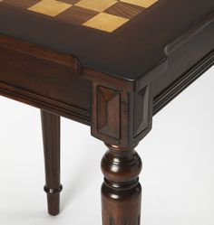 a close up of a chess board on a table with two legs and one leg missing