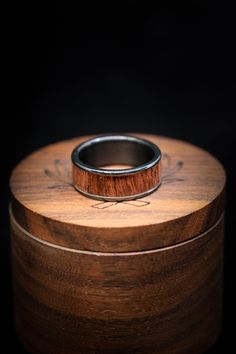 a wooden box with a ring on it