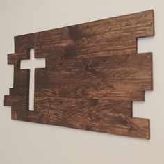 a piece of wood with a cross cut out of it