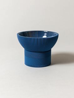 a blue bowl sitting on top of a white table