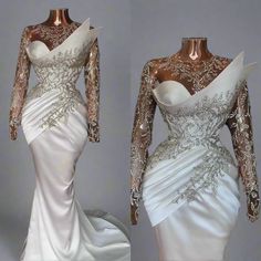 a white wedding dress with gold detailing on the shoulders and long sleeves, is shown