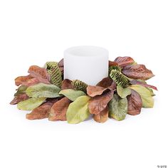 a white candle surrounded by leaves on a white background