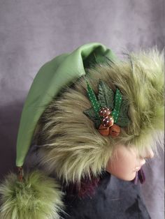 SIZING All hats fit average heads of 22 to 23 inches, long hats are two feet long.  These are all made and ready to ship!!     This hat is made from a gorgeous mossy green leather and it is trimmed with an olive green faux fur that has a faint dusting of charcoal at the tips for a beautiful depth to the fur. I'm calling this my Forest nymph hat because it is calling out with all the rich greens and browns of the Forest! The brims are cut generously so they can be cuffed down for added fullness. Adjustable Green Costume Hats With Short Brim, Green Adjustable Fitted Hat With Short Brim, Adjustable Green Bonnet Cap, Green Brimmed Winter Costume Hats, Green Winter Costume Hats And Headpieces, Adjustable Green Brimmed Mini Hats, Adjustable Brimmed Green Mini Hats, Green Flat Brim Hat, One Size Fits Most, Adjustable Green Hat Headpiece