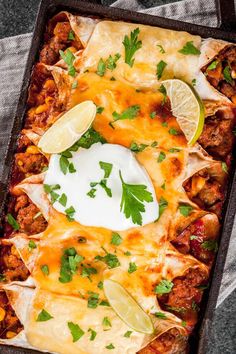 an enchilada dish with meat, cheese and cilantro on top