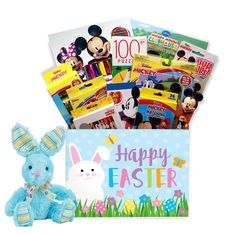 a blue stuffed animal sitting next to a box filled with books and candys for children's easter baskets