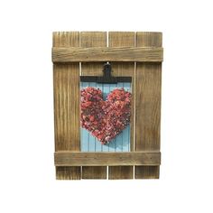 a wooden frame with a heart shaped decoration hanging on the front and side of it