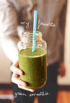 a person holding a green smoothie in a mason jar with the words, my favorite