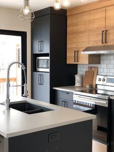 a modern kitchen with stainless steel appliances and wood cabinets