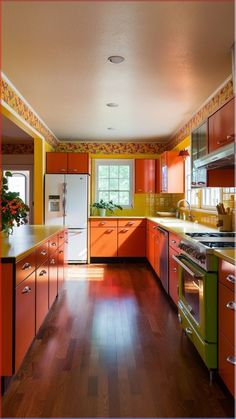 an orange and green kitchen with wood floors