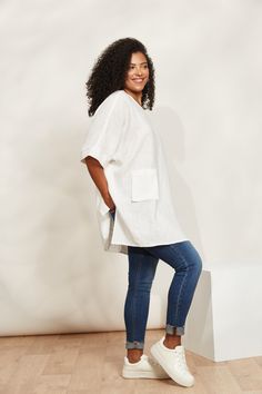 STYLE DETAILS: Enjoy carefree summer days in style with the Halcyon Relaxed Top, crafted from 100% linen. Its relaxed fit and contemporary tunic design, featuring high-side vents, ensure you stay cool and comfortable all season long. Pair it with matching linen shorts or loose pants for an effortless look perfect for soaking up the sun and embracing those relaxed summer vibes. FEATURES: Round neck Elbow-length sleeves Patch pocket High side vents Relaxed fit 100% Linen One Size Jacket Cape, Poncho Jacket, Tunic Designs, Linen Bottoms, Unique Fits, Loose Pants, Mid Dresses, Mid Length Dresses, Knitwear Cardigan