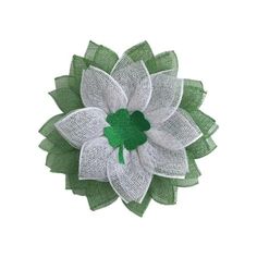 a green and white flower with a shamrock on it's center, in the shape of a leaf