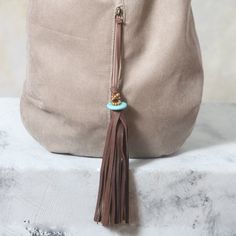 This large leather tote is designed with simple lines. It is feminine and strong. A hobo bag that has a generous amount of room for you to carry all your daily necessities and much more. It has one large exterior zipped pocket on the front of the bag and two inside. The outside zipper features a handmade leather tassel with a turquoise stone. The strap is hand braided leather. Handmade by me using extremely strong and fine Italian leather and lined with a durable fabric inside. The leather is qu Handmade Beige Shoulder Bag For On-the-go, Modern Everyday Tote Bag, Brown Leather Handles Shoulder Bag For Everyday, Brown Leather Handle Shoulder Bag For Everyday, Bohemian Everyday Clutch Bag, Bohemian Clutch Bag For Everyday Use, Beige Tote Hobo Bag As Gift, Hobo Satchel Bag With Leather Handles As Gift, Everyday Hobo Tote Bag With Removable Pouch