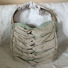 Dimensions: Width = 13-1/2"; Length (Purse Only) = 11-1/2"; Length (With Shoulder Strap) = 23"; Base Width = 4-1/2"; Side Width: 5-1/2" Anthropologie Miss Albright Philadelphia Mint Green Shoulder Bag. Crinkle Chiffon (?) Knotted Fabric On Front With Raw Edges. Tan Leather Shoulder Straps. One Zipper Pocket And Two Open Pockets On Inside. Gingham Lining Inside. Magnet Closure -- One Pair On Each Side Of The Open Purse. Nwot - Paper Protection On Strap Still Intact. Excellent Condition; No Tags But Never Used Stylish Camera Bags, Green Shoulder Bag, Gingham Jacket, Asics Running Shoes, Swim Shoes, Basket Bag, Boot Bag, Leather Chain, Green Bag