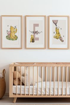 three winnie the pooh prints hang above a crib