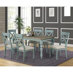 a dining room table with six chairs and a rug