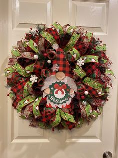 a christmas wreath hanging on the front door