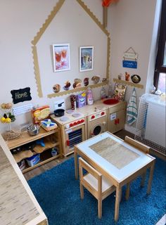 a child's playroom with wooden furniture and pictures on the wall