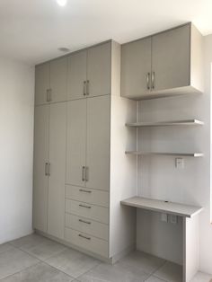 an empty room with some shelves and cupboards